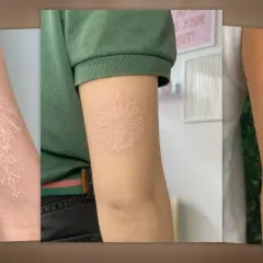 Drei Arme mit filigranen weißen Tattoos: eine Rose mit Blättern, eine Gänseblümchen und eine Palme.